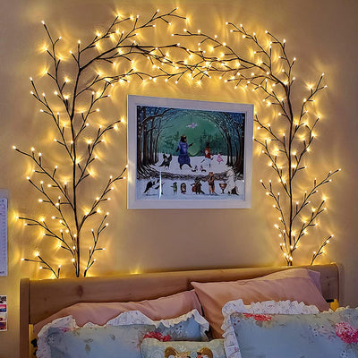 Festive Christmas garland decorated with green vines and warm white string lights, perfect for holiday indoor or outdoor decoration