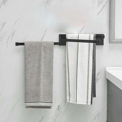Nordic non-perforated towel rack in black, holding two towels in a modern bathroom setting.